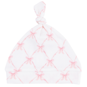 The Angel Dear Knotted Hat features a light pink crisscross pattern with pink bows at each intersection, crafted from soft bamboo for babies.