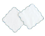 Two white wash cloths from Terry Tots, featuring delicate blue floral trim and elegant scalloped edges, slightly overlapping each other, are displayed on a white background.
