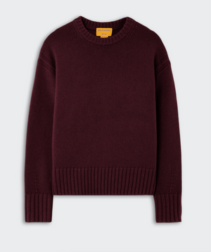 The Cozy Crew Cashmere Sweater by Guest in Residence is a long-sleeve, dark burgundy knit featuring a cozy crew neckline, ribbed cuffs, hem, and collar, and a relaxed dropped shoulder design, shown against a plain light background.