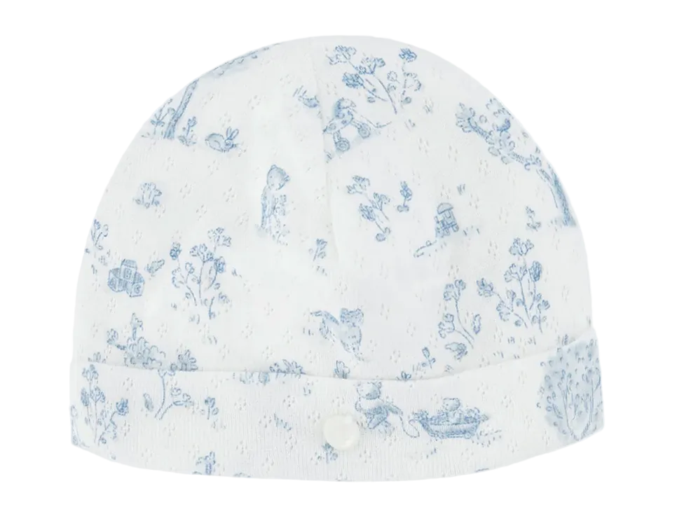 The Tartine et Chocolat Baby Fantasy Garden Cotton Beanie is crafted from soft white cotton and showcases a light blue floral and animal fantasy garden print, finished with a small button detail on the folded brim.