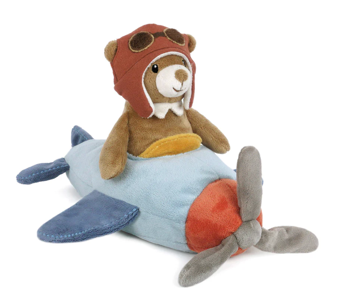 Mon Ami’s Pilot Bear is a brown teddy bear wearing an aviator cap, seated on a blue and gray vintage-style airplane with a red nose and soft propeller—perfectly capturing the nostalgic charm of classic pilot adventure plush.