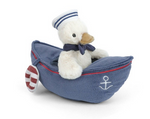 Meet the Mon Ami Sailor Duck—a delightful plush toy featuring a charmingly dressed sailor duck nestled inside a blue nautical plush boat, complete with an anchor emblem and a striped paddle on the side. This adorable Sailor Duck is the perfect companion for little adventurers!.