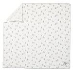 Tartine et Chocolat Cotton Swaddle in white features a subtle gray animal print and neatly stitched edges, with one corner folded to reveal the reverse side—an adorable and cozy nursery essential.