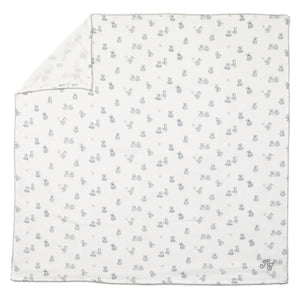 Tartine et Chocolat Cotton Swaddle in white features a subtle gray animal print and neatly stitched edges, with one corner folded to reveal the reverse side—an adorable and cozy nursery essential.
