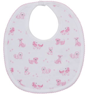 The Kissy Kissy Puppy Paws Printed Bib features soft white Pima cotton decorated with playful pink cartoon puppies and puppy paw prints, finished with a delicate pink scalloped trim and secured at the neck with an easy snap button.