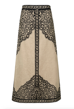 Johanna Ortiz Loose Horizon Ankle Skirt in beige, featuring an A-line silhouette, a black decorative border, and an intricate abstract print.